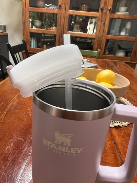 a purple stanley quencher tumbler with it's screw off lid