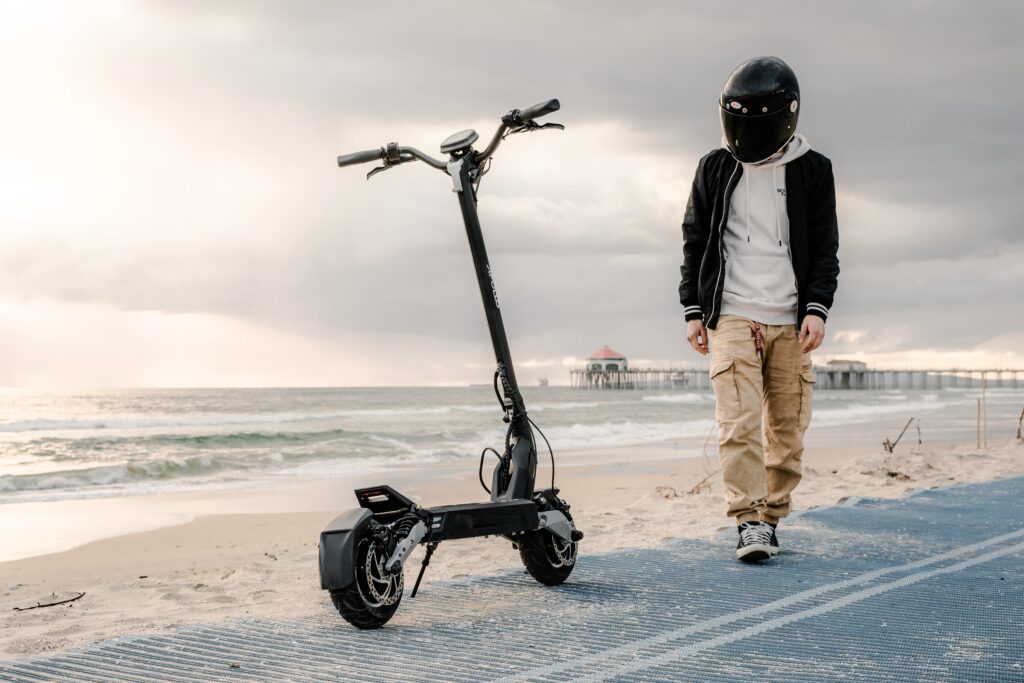 an electric scooter and a man with a helmet